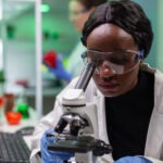 Biologist researcher examining organic leaf slide for medical expertise