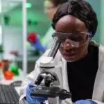 Biologist researcher examining organic leaf slide for medical expertise